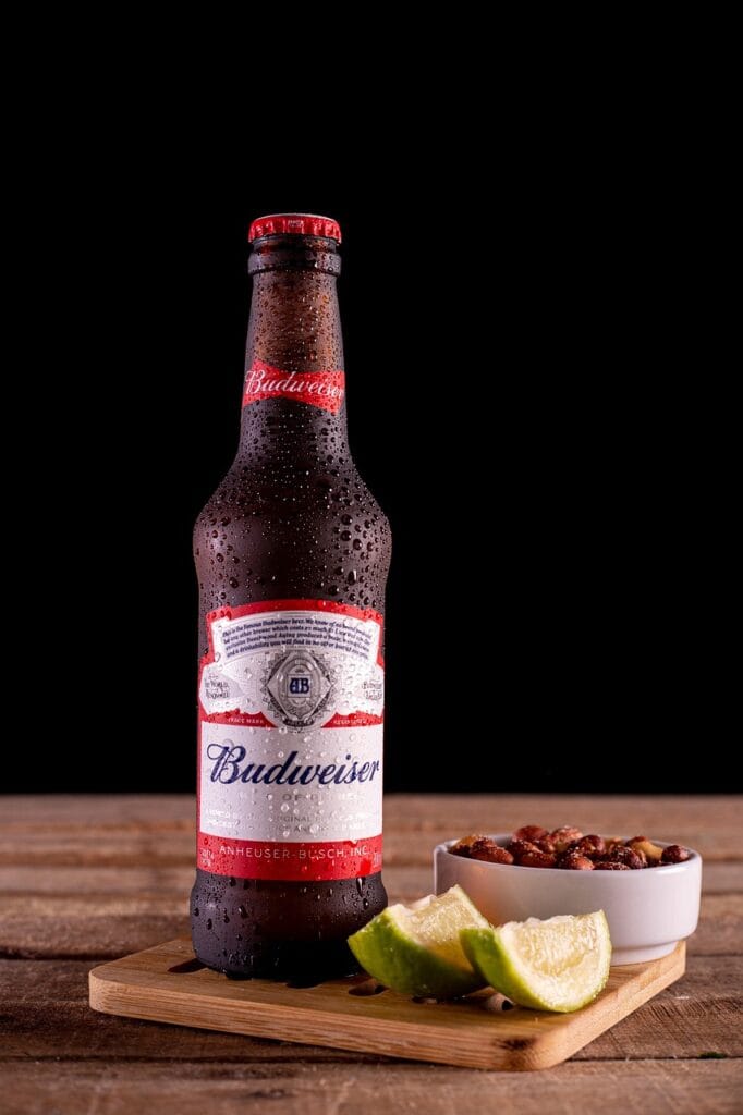 beer, peanuts, lime, budweiser, cold beer, bottle, bottle of beer, beer bottle, bowl, bowl of peanuts, bar, drink, alcoholic drink, beverage, alcoholic beverage, budweiser, budweiser, budweiser, budweiser, budweiser