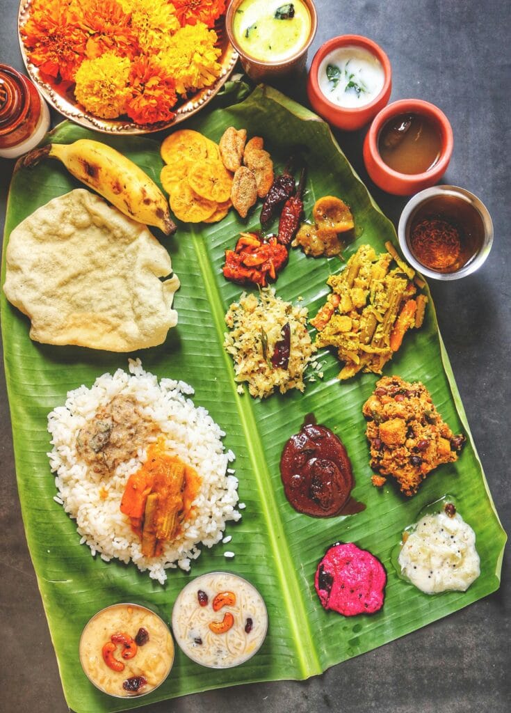 pexels-photo-5410418-5410418 A vibrant display of Kerala Sadya on banana leaf, featuring traditional Onam dishes.