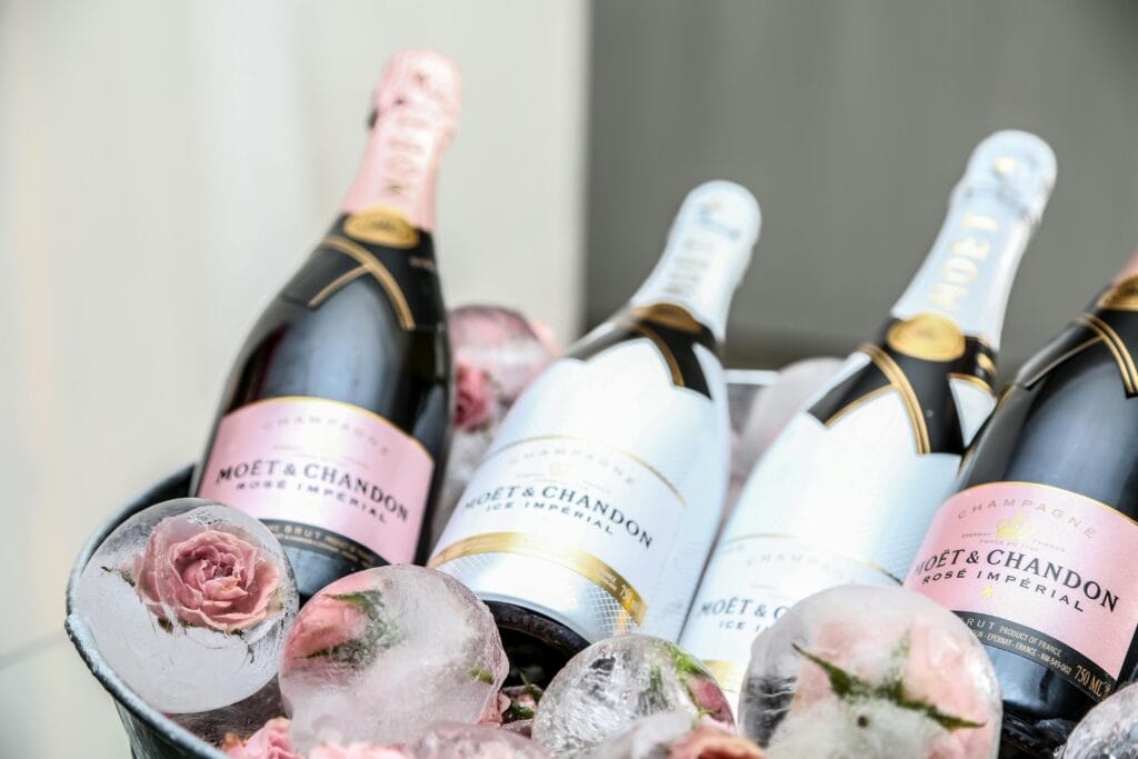 Elegant display of Moet & Chandon champagne in an ice bucket adorned with roses, perfect for celebrations.