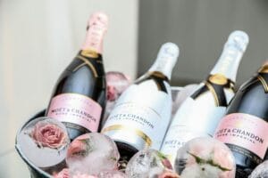 Elegant display of Moet & Chandon champagne in an ice bucket adorned with roses, perfect for celebrations.